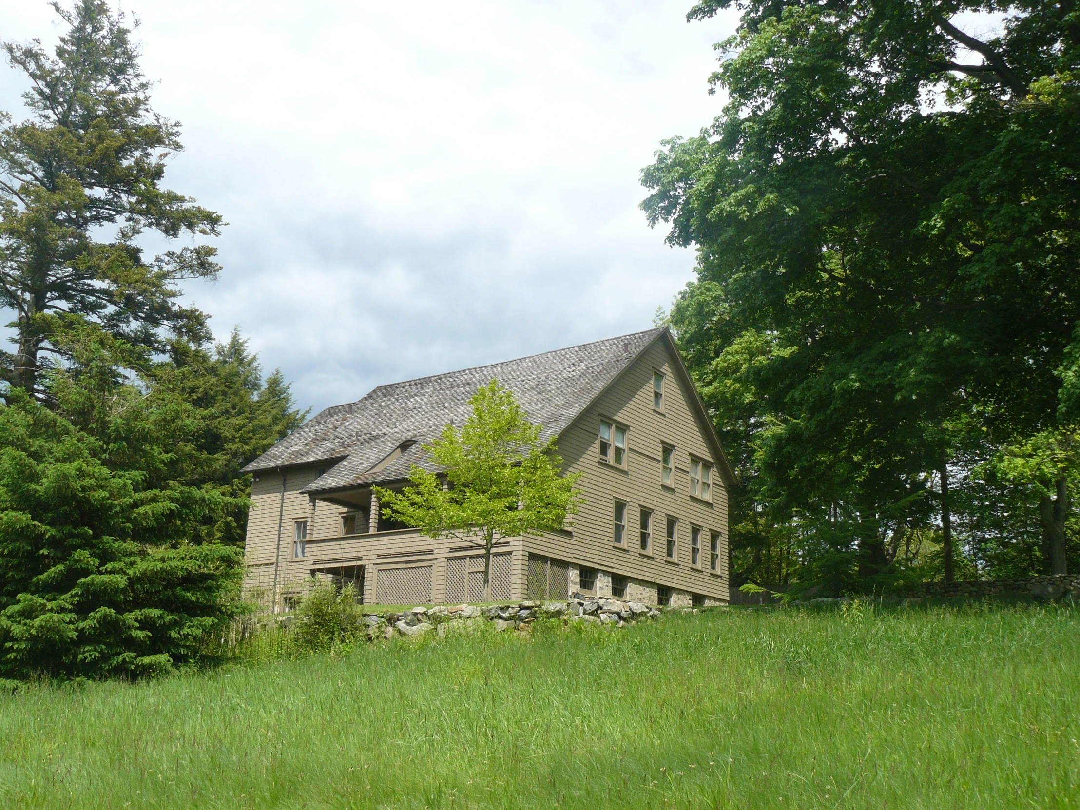 a large home is standing in the middle of a lush green area