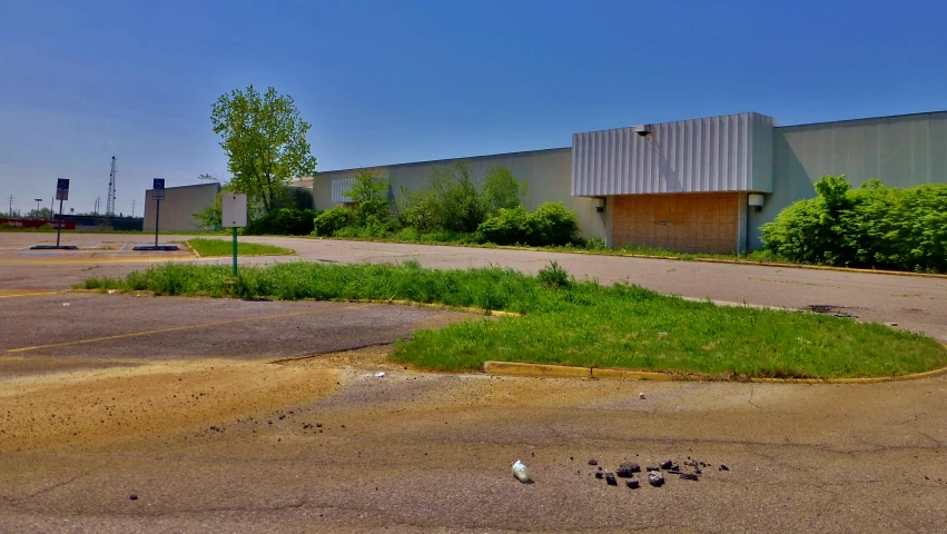 an old factory building that's vacant in the parking lot