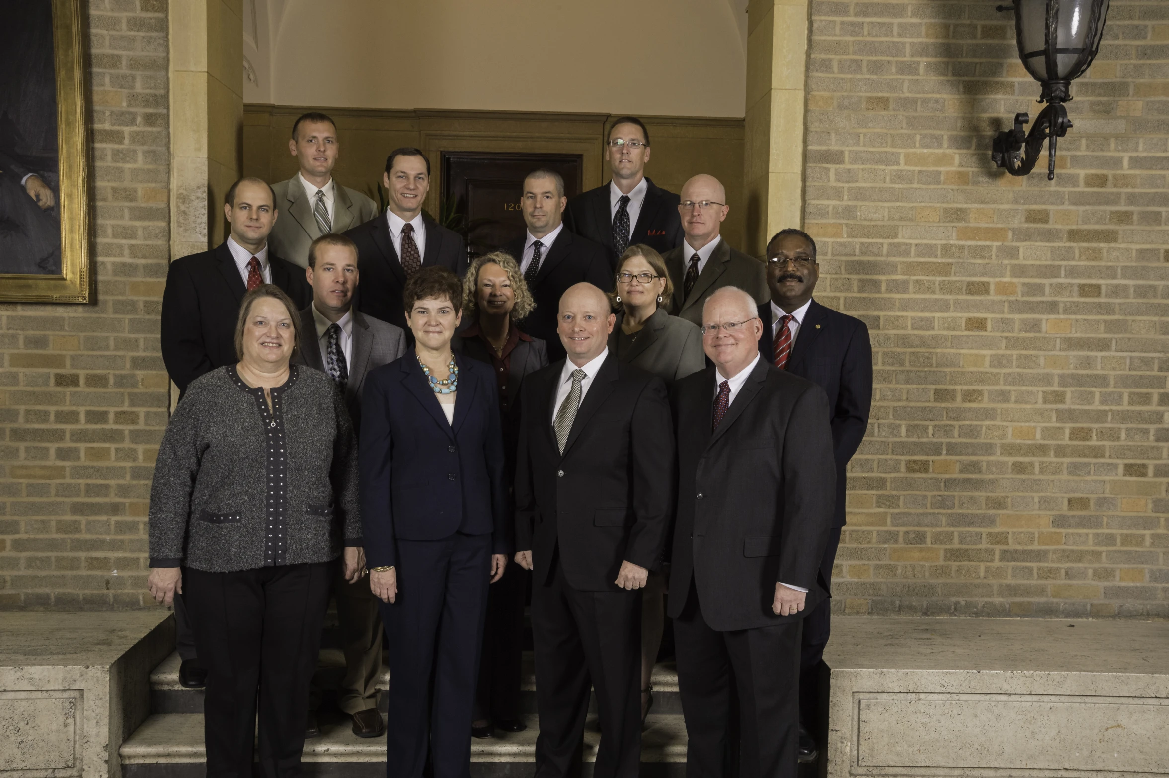 a group of people in suits and ties standing on steps