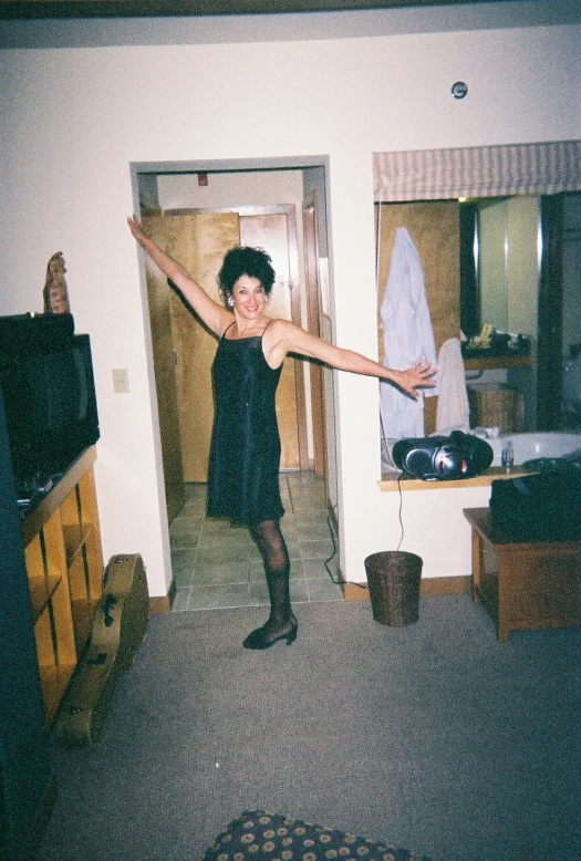 the woman in the room is standing in front of her kitchen sink