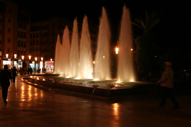 the water jets are fountaining in the public square