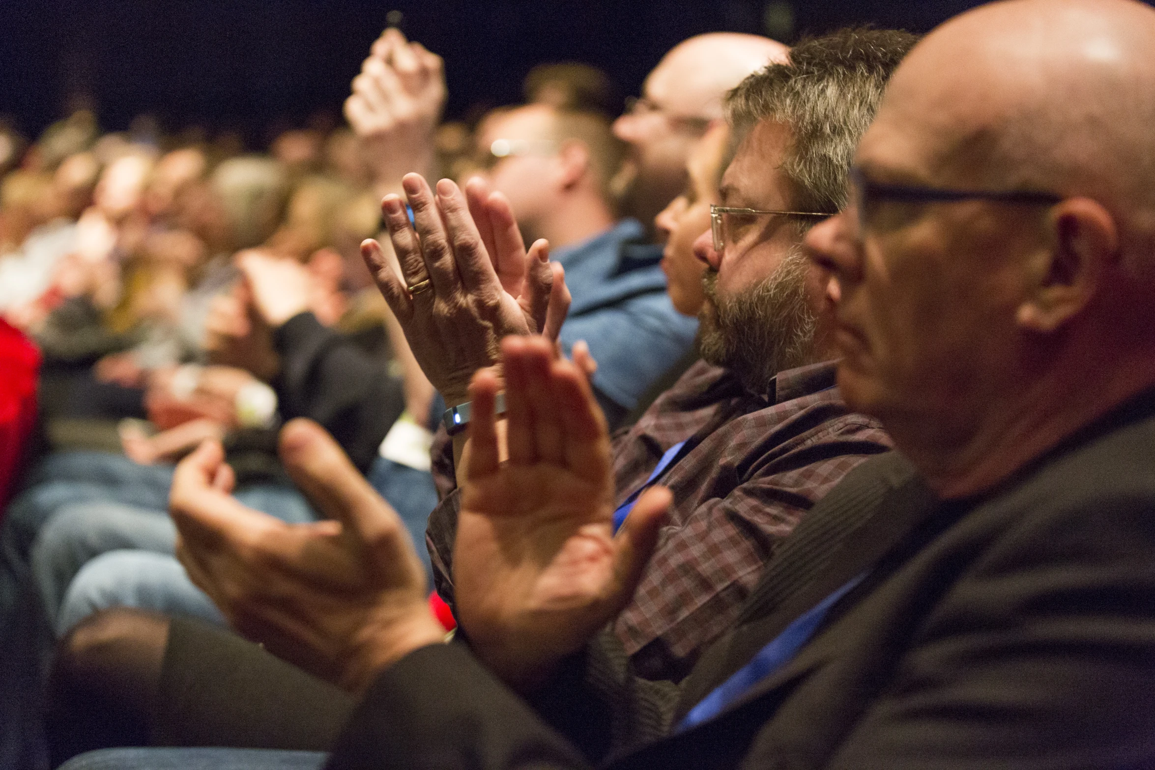 people clapping at a public event on the go