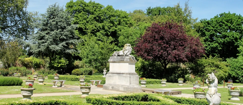 a statue surrounded by a number of planters with sculptures on top of them