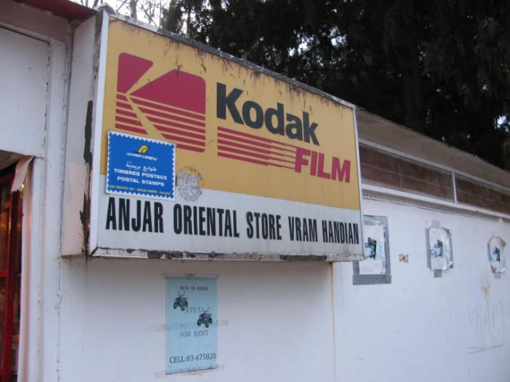 kodak camera sign hanging on a wall