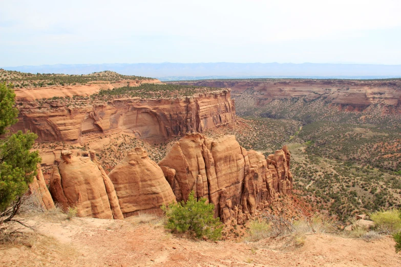 the view of a desert cliff in the middle of a plain