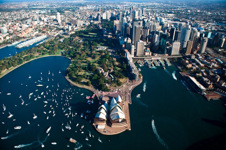 an aerial view of a city with lots of boats in the water