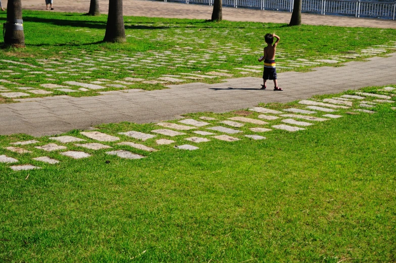 two small children play with each other in a park