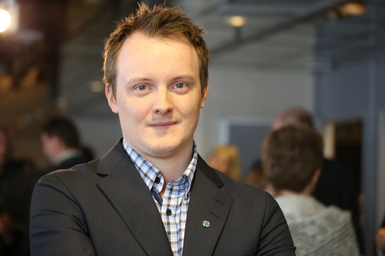 a close up of a person wearing a jacket and tie