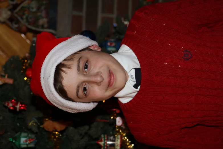 a  wearing a red sweater and christmas hat