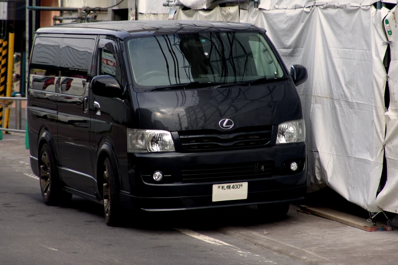 a large black van is parked on the side of the road