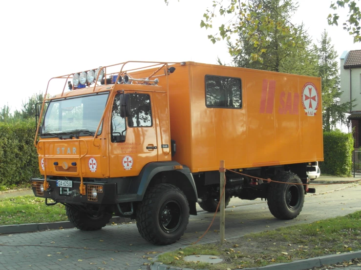 the large orange utility truck has four seats