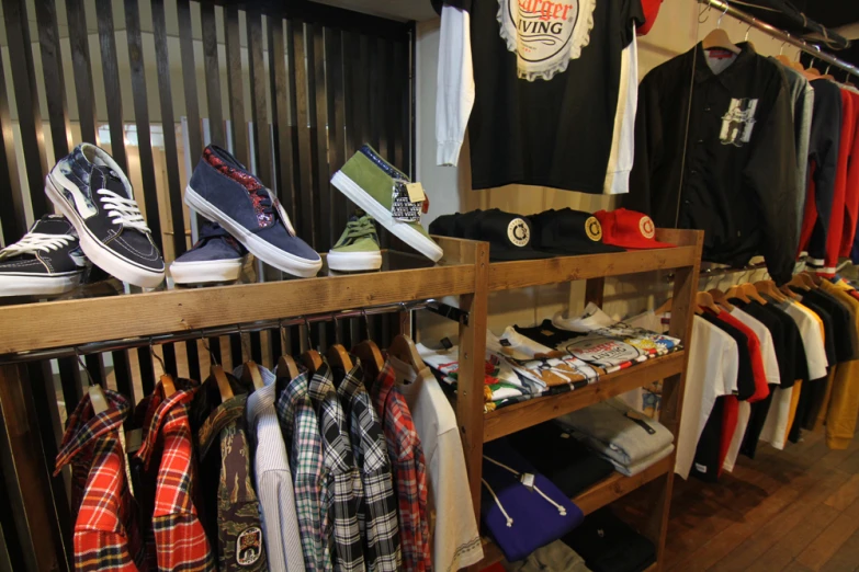 clothing and sneakers on racks in a retail store
