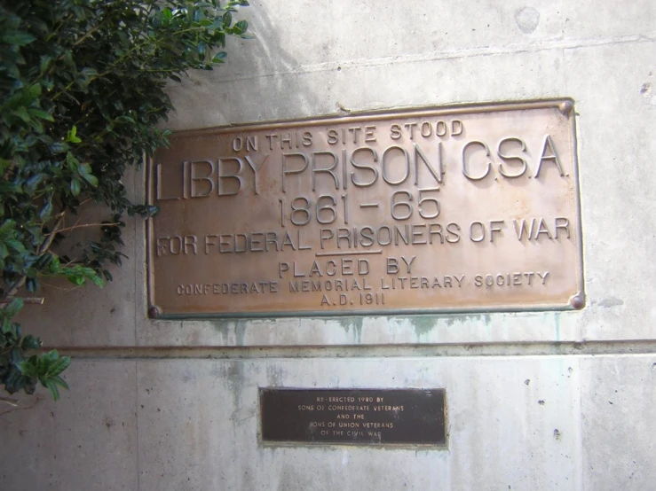 a plaque is placed against a cement wall