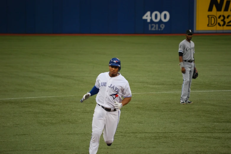 a baseball player is running on the field