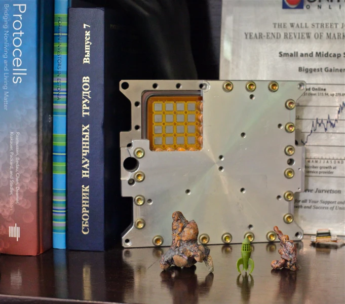 several electronic components sitting on a desk next to books