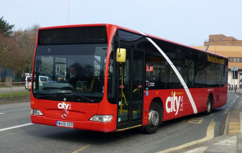 a red bus turning on the street