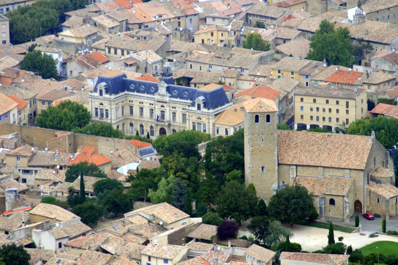 the brown and beige roofs of the roofs are visible from the tower