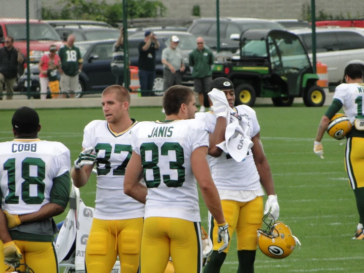 several football players on a field with many people