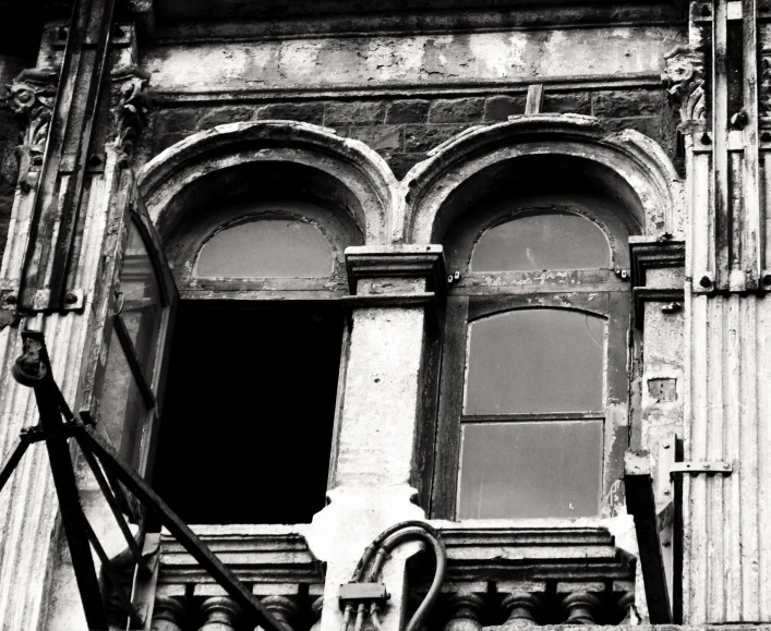 a black and white image of an old building window