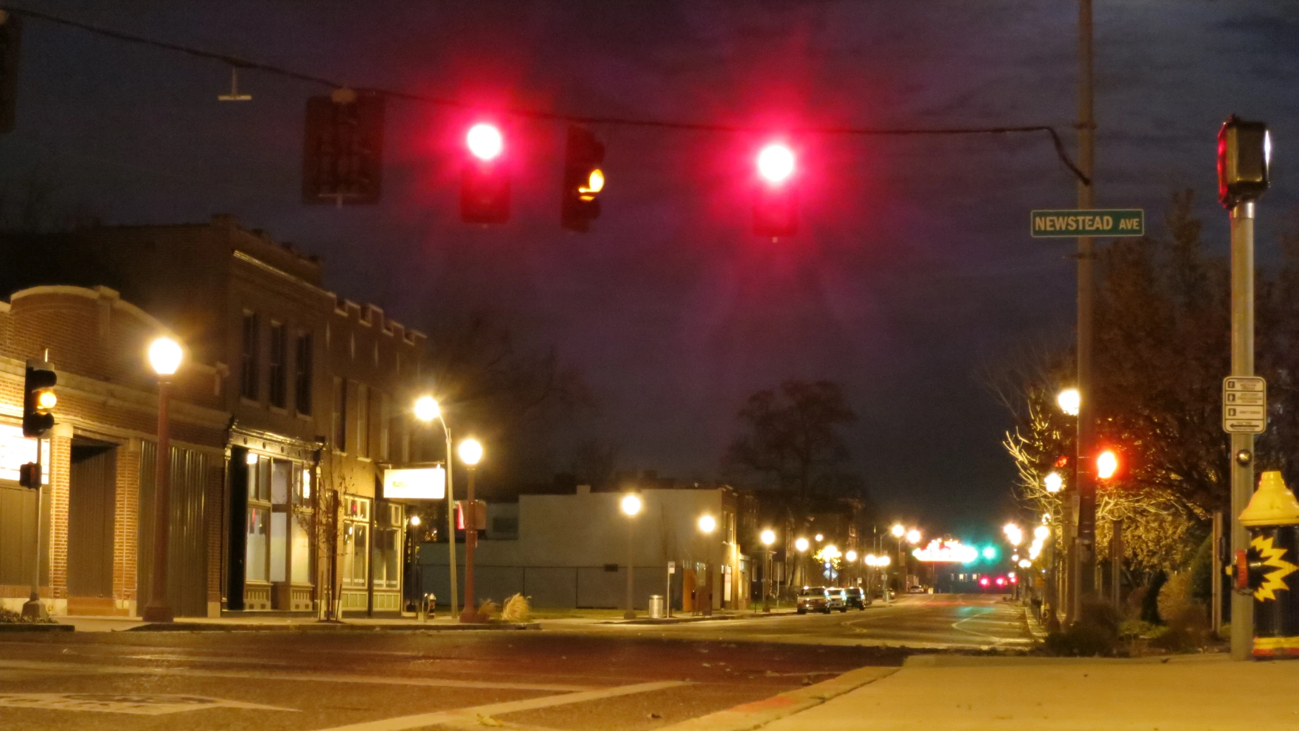 a stoplight on the corner of a street at night