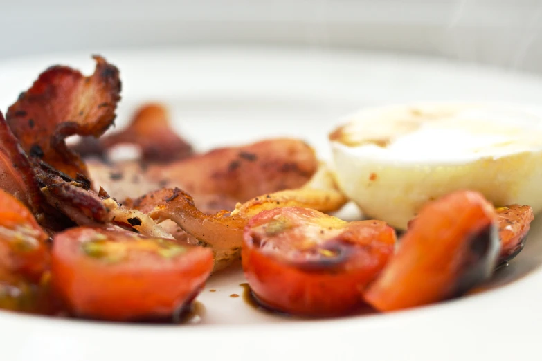 bacon, tomato, and hard boiled egg on a plate