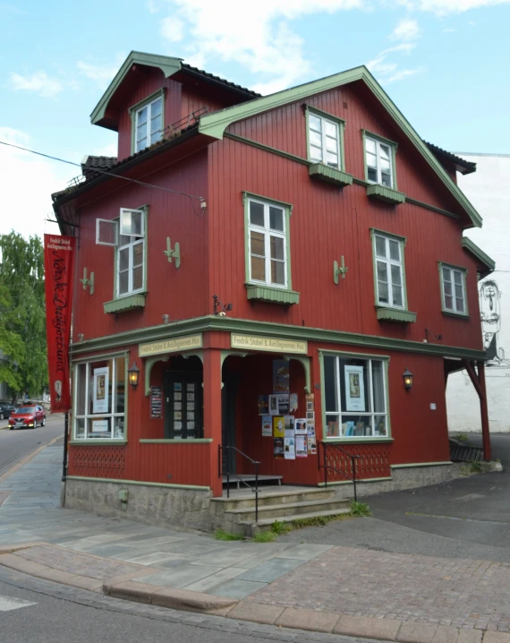 the building in front of it has a sign and flags on it