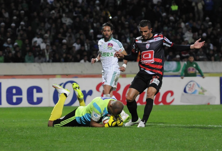 two men on the soccer field near a referee