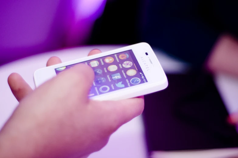 close up of the hands of someone holding a smartphone