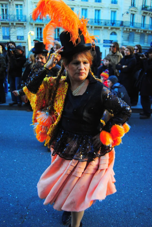 a woman with long red hair, wearing a pink skirt and hat