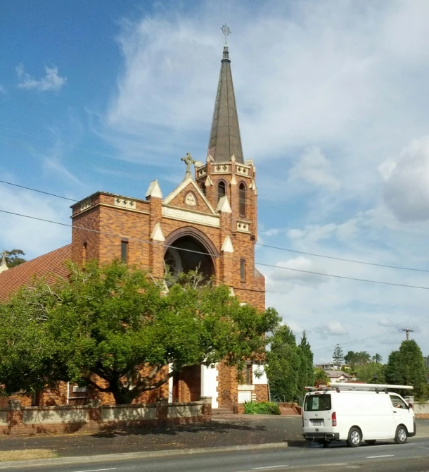 a big church with a large tall steeple next to it