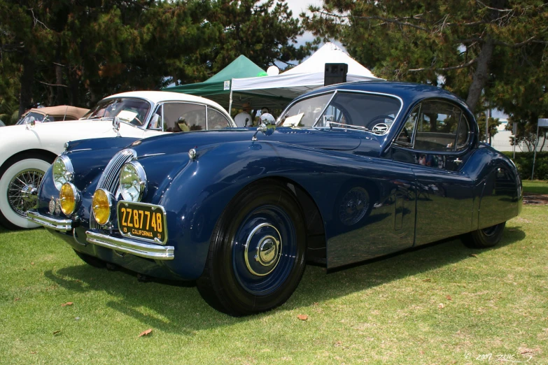 antique vehicles are parked in an open area