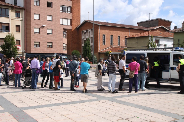 a large group of people are standing around outside