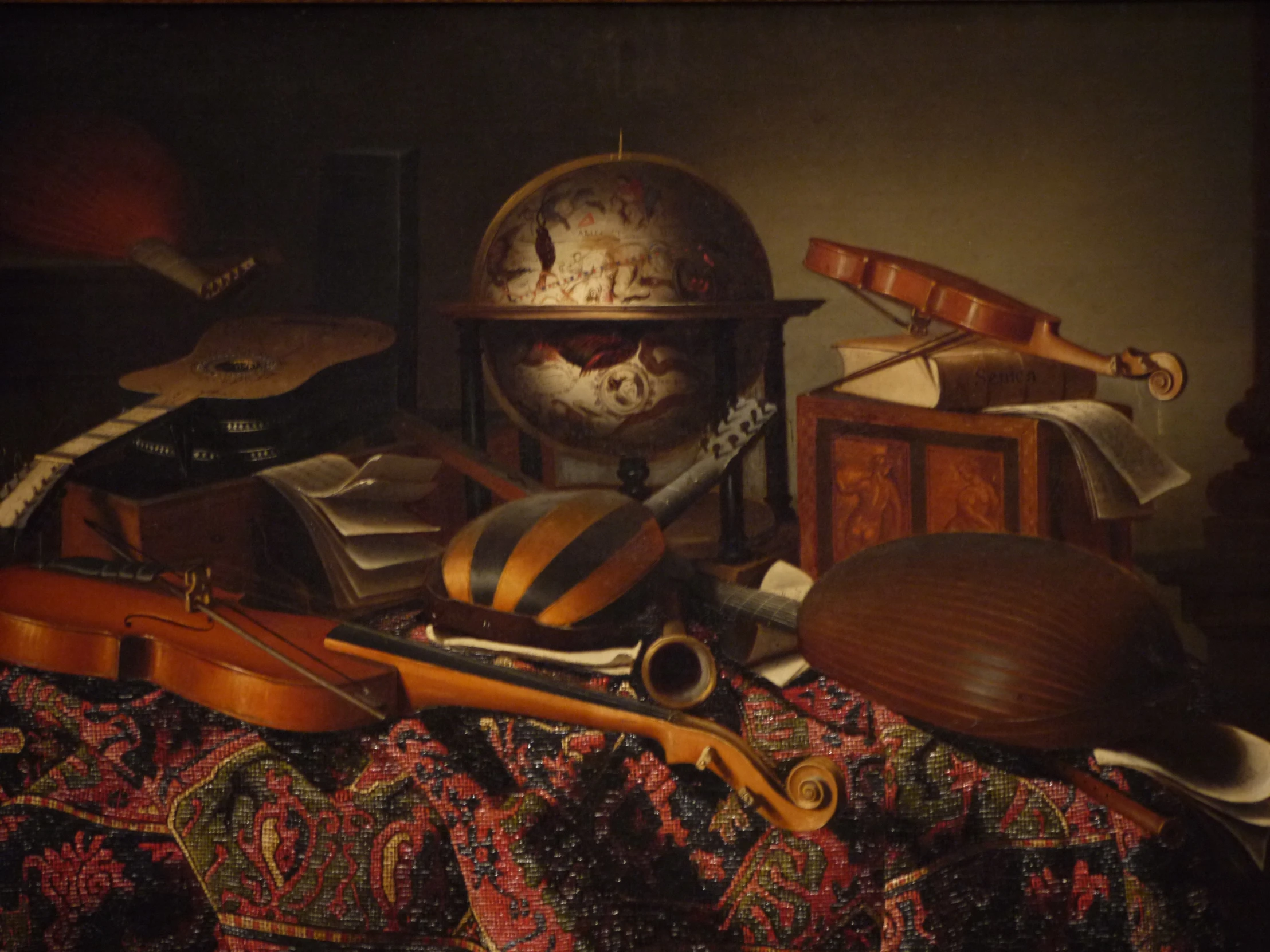 the guitar, musical instruments and box are next to the other objects