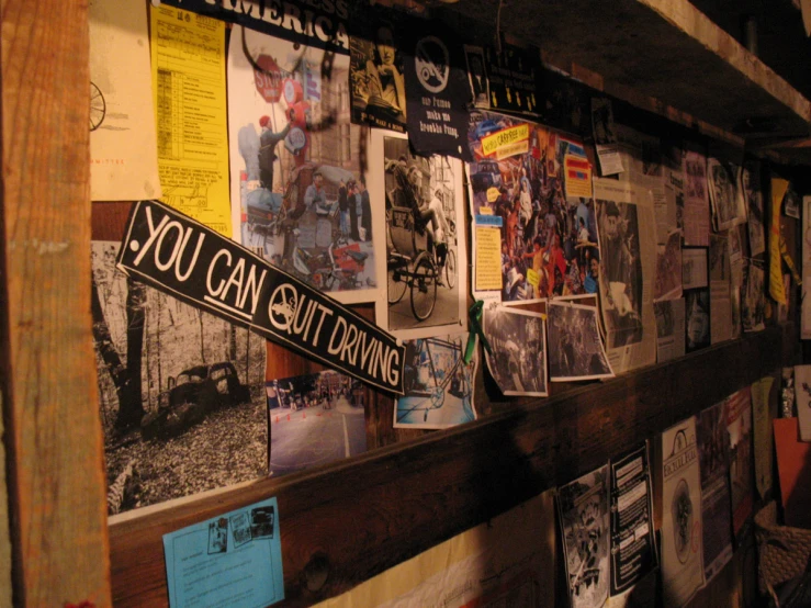 a wall covered in papers and signs with writing on it