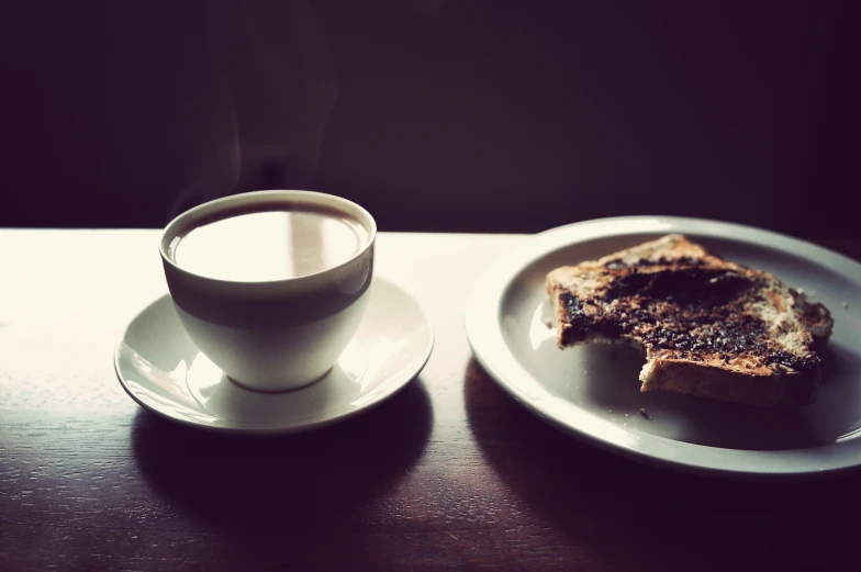 a plate with food and drink sit on a table