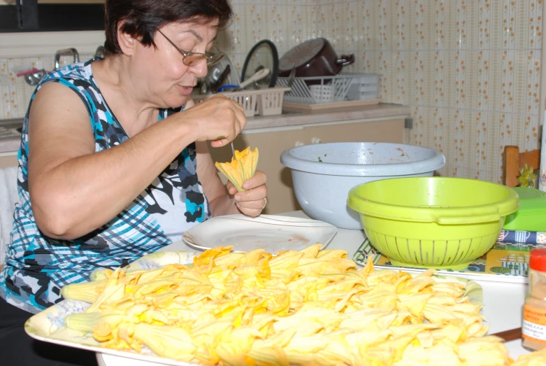 a lady that is making some kind of food