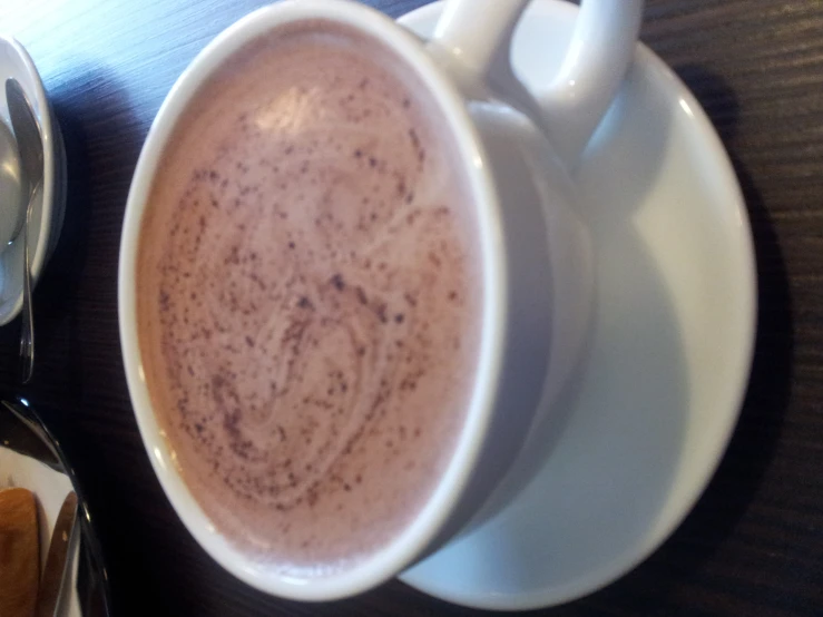 a cup of chocolate sits on a saucer