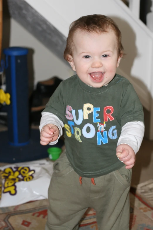 baby with one arm and two eyes walking across carpet