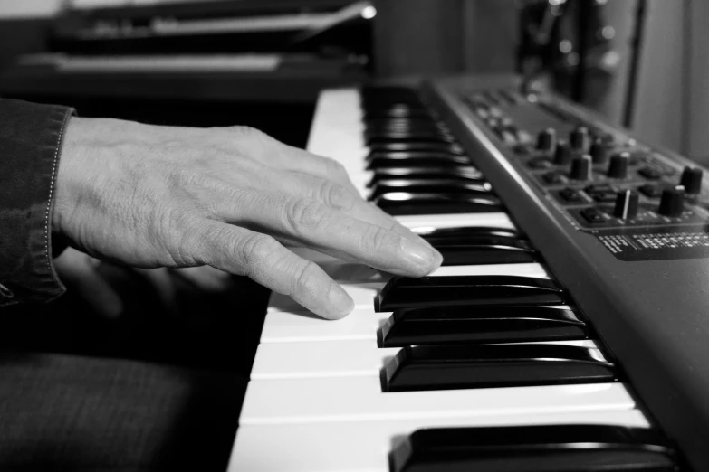 a hand is resting on the piano keys