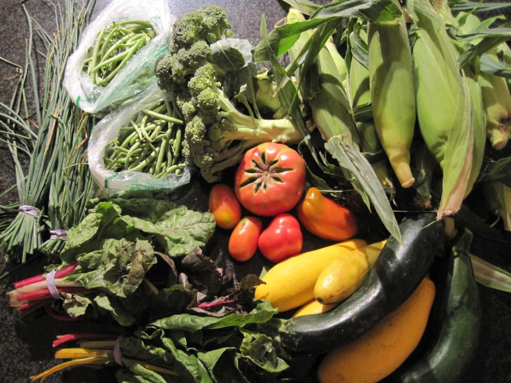 a table top with a bunch of fruit and vegetables on it