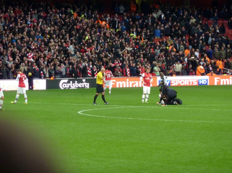 the people are playing soccer on the field