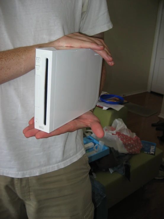 a man holding an apple computer in his hands