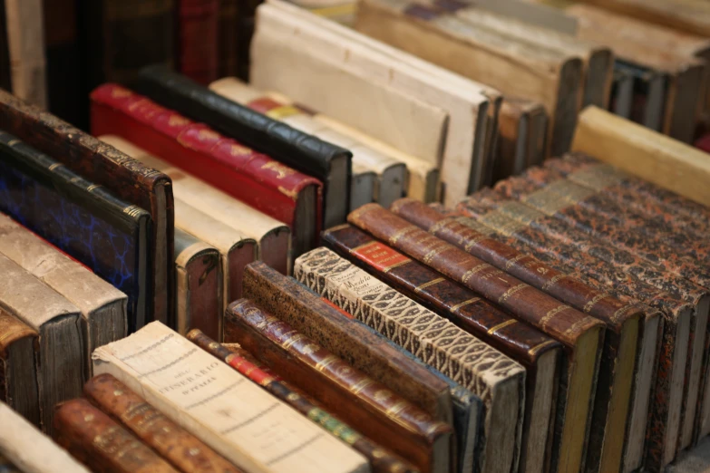 many old books are displayed together in the same bunch