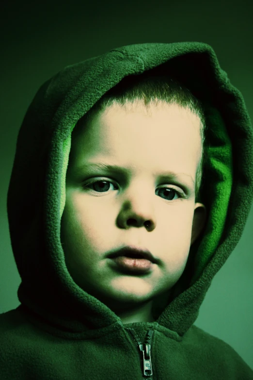 an image of a child with green hoodie