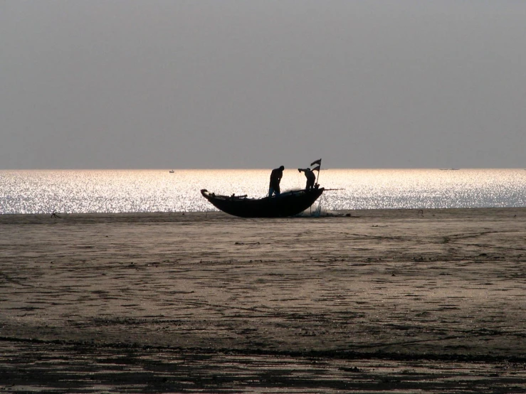 a small boat traveling through the ocean with two people on it