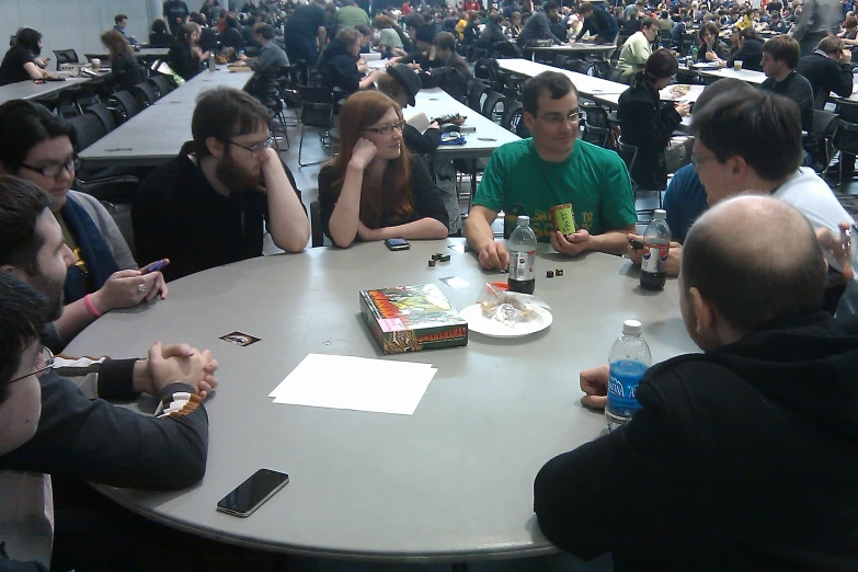 people at table with cellphones around it in an event