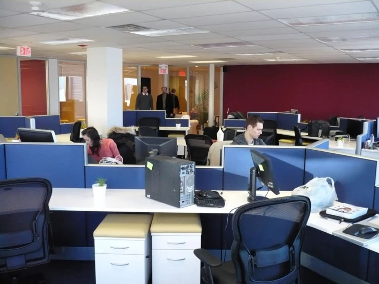 three cubicles of cubicles with people in them