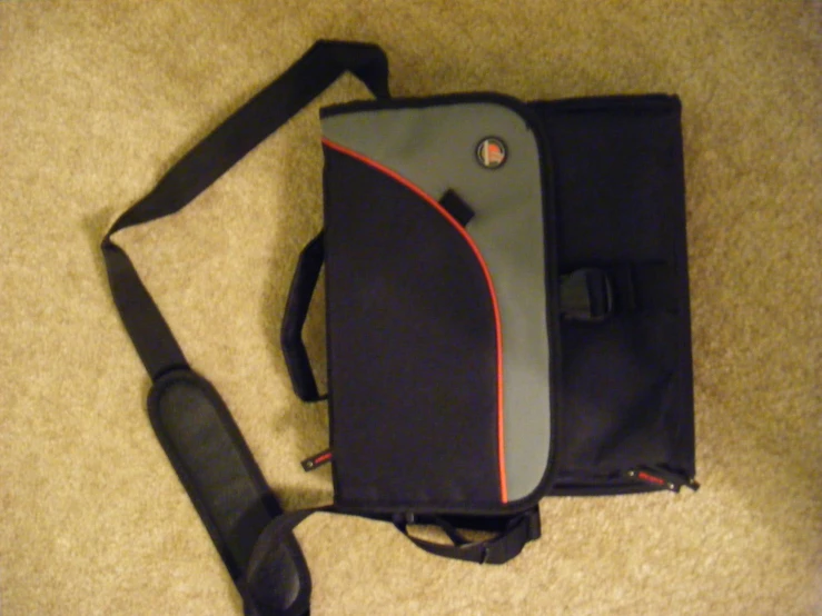 a black, gray, and red laptop bag with handles