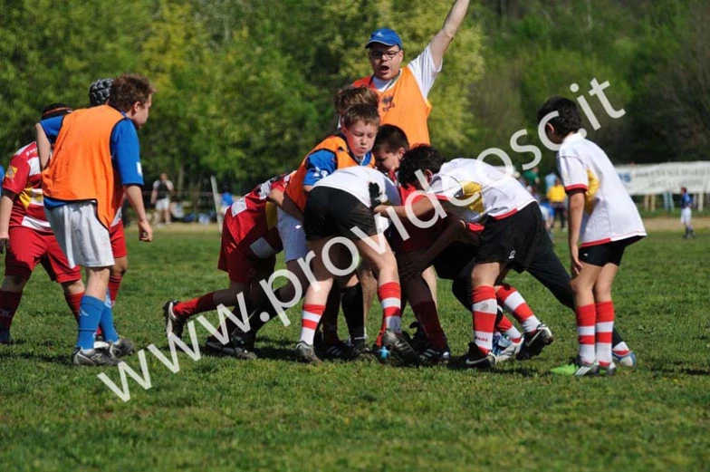 a team of children on field playing with soccer