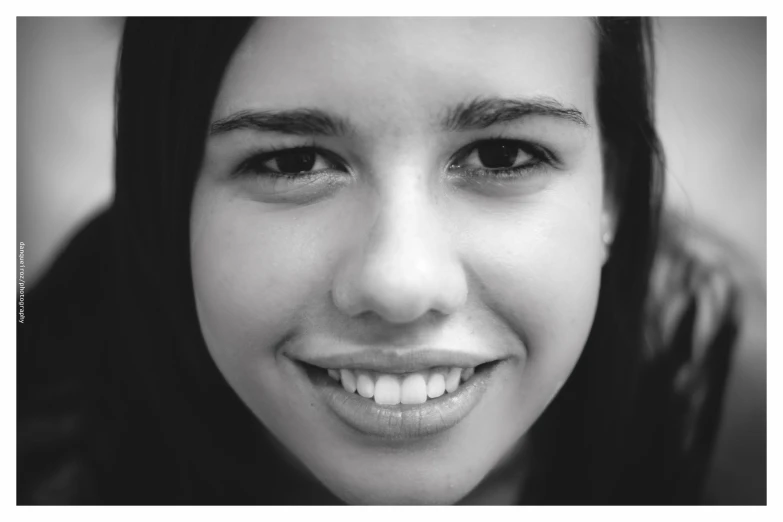 a woman in black shirt smiling at camera